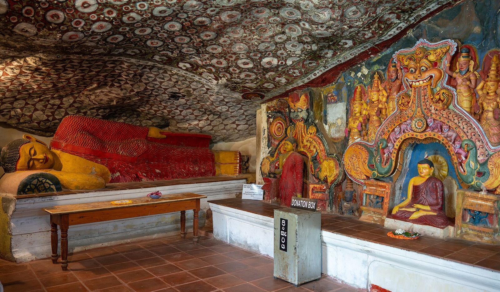 Painted ceiling and reclining Buddha inside the Dambulla cave temple