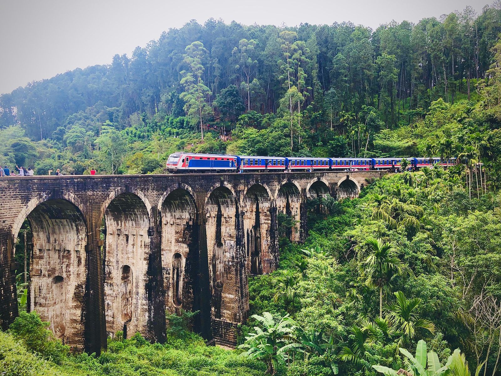 Blue train crossing the Nine Arch Bridge