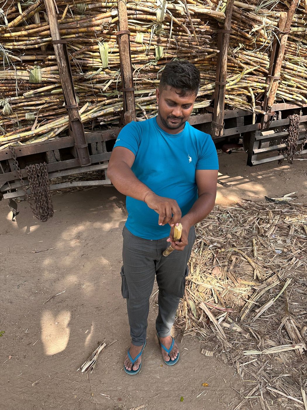 Nipuna opening a king coconut at a roadside stall